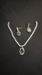 Necklace with a dazzling oval pendant and a matching pair of drop earrings