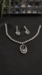 Necklace with a dazzling oval pendant and a matching pair of drop earrings