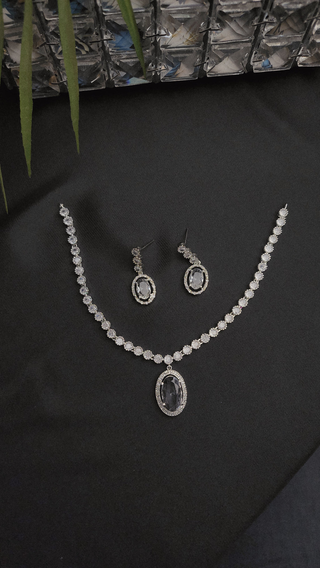 Necklace with a dazzling oval pendant and a matching pair of drop earrings