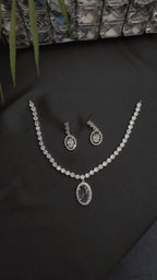Necklace with a dazzling oval pendant and a matching pair of drop earrings