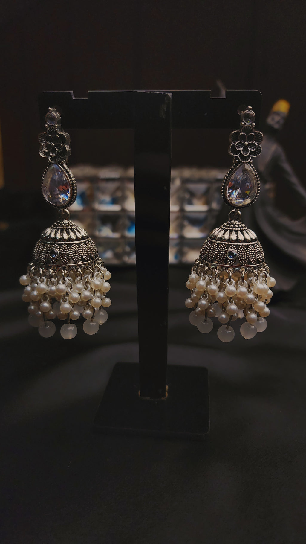 A pair of ornate, silver-toned Indian jhumka earrings 🌸🎀