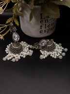 A pair of ornate, silver-toned Indian jhumka earrings 🌸🎀