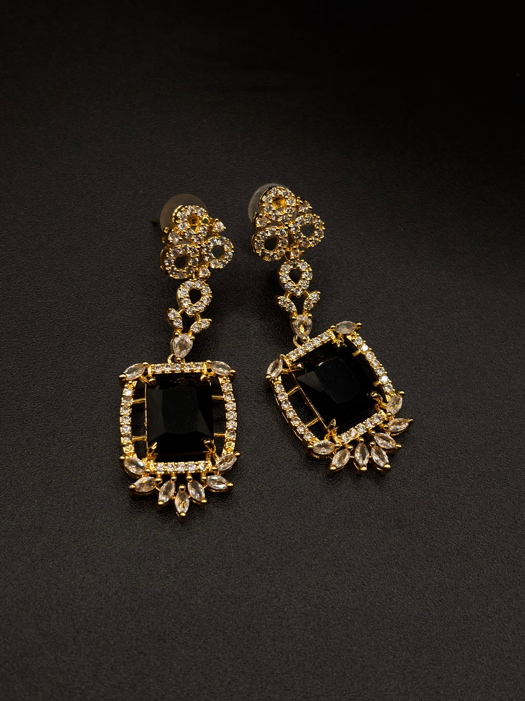 Striking black central stone, intricately framed by sparkling cubic zirconia EARRINGS